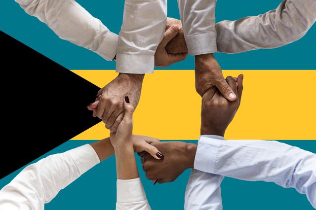 Bahamas Flag with four sets of hands shaking in forground 