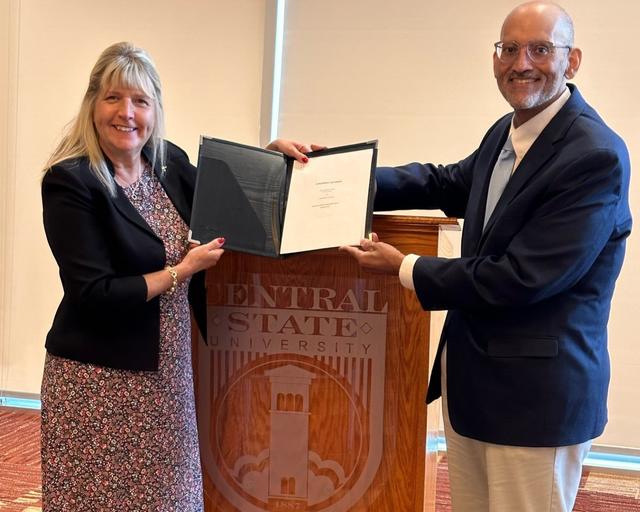 Barbara C. DiGiacomo of the University of Akron School of Law C. Blake McDowell Law Center and Sidney Williams of the Central State University Graduate School Preparation Program  holding an agreement recognizing the launch of the new three plus three program