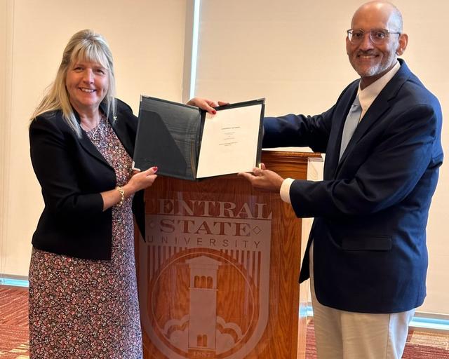 Barbara C. DiGiacomo of the University of Akron School of Law C. Blake McDowell Law Center and Sidney Williams of the Central State University Graduate School Preparation Program holding an agreement recognizing the launch of the new three plus three program