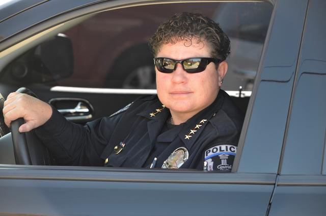 Central State University Police Chief Stephanie Hill looks out her police cruiser's driver's side window while wearing her uniform and sunglasses