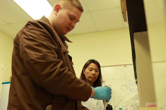 Central State University's Dr. Hongmei Li-Byarlay with a student in the University Bee Lab