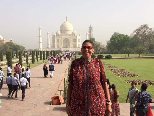 glenda jones stands in front of a mosque in the background