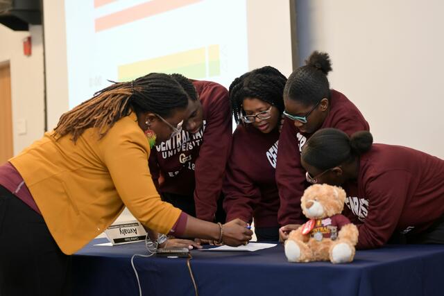 The trivia team members and their advisor collaborate during the 2025 National Qualifying Tournament in Alabama