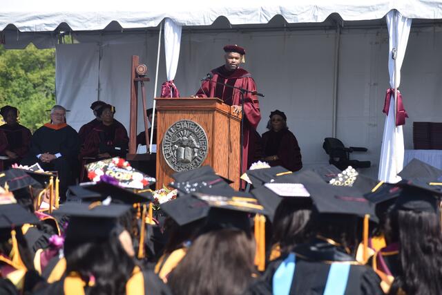 dr. myron l. rolle in front of the class of 2025