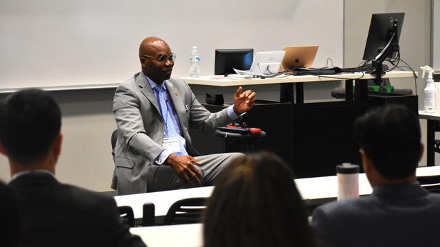 a black man in a suit using a wheelchair