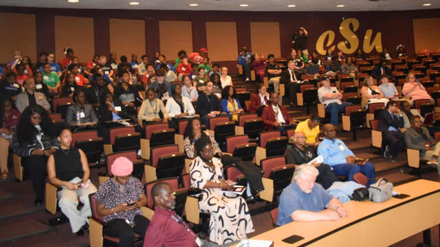 An audience for student research poster presentations in the College of Business Smith Hall