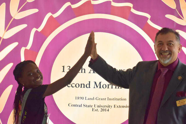 Kendall Rae Johnson United States Department of Agriculture Urban Agriculture Youth Ambassador high-fives Dr. Jose Toledo