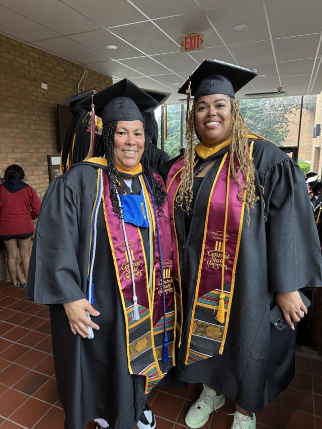 Alethea Davis and Tia Boston in graduation caps and gowns