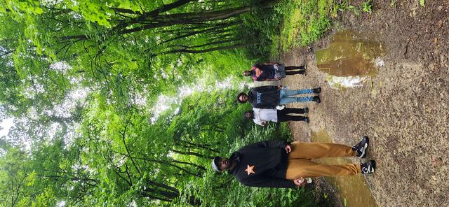 a group of young men on a path in a forest