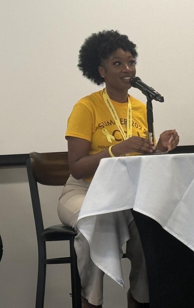 alexis luckie speaks into a microphone