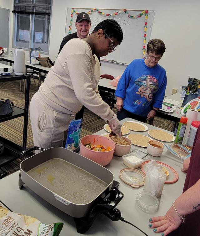 three people serve up delicious food through central state university extension healthy cooking classes