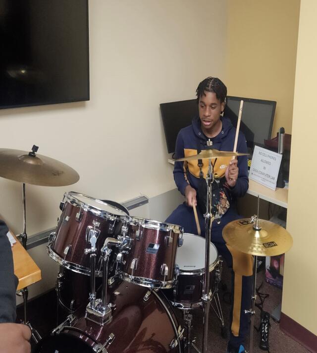 a young man plays the drums