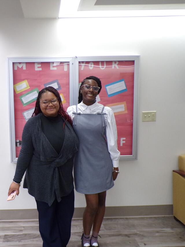 two young black women with arms around each other