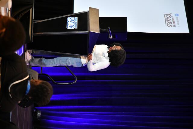 Darcey speaking at the podium at SIAC